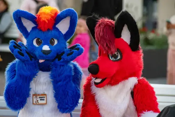 Adult furry and pup community members talking together in a neon social lounge.