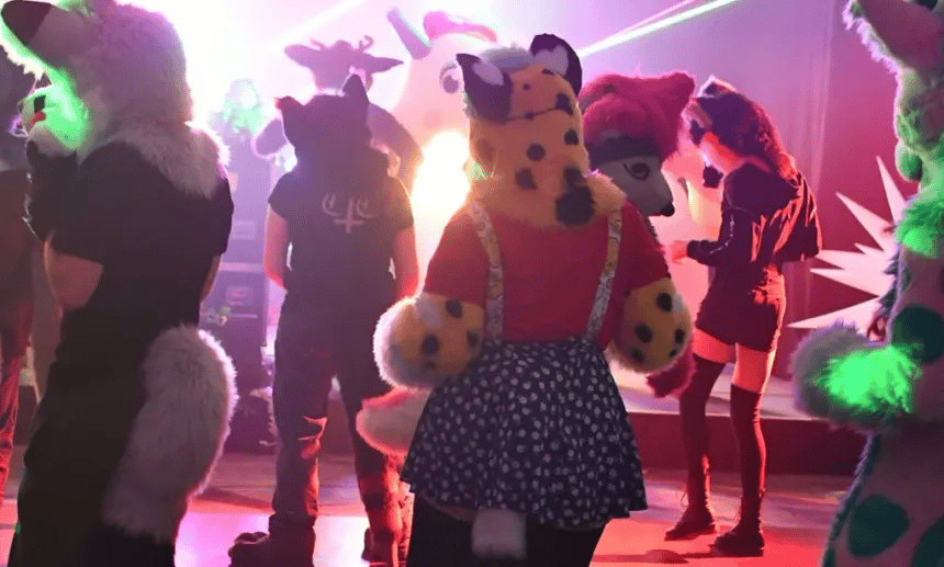A diverse group of digital avatars interacting peacefully in a vibrant VRChat community hub.